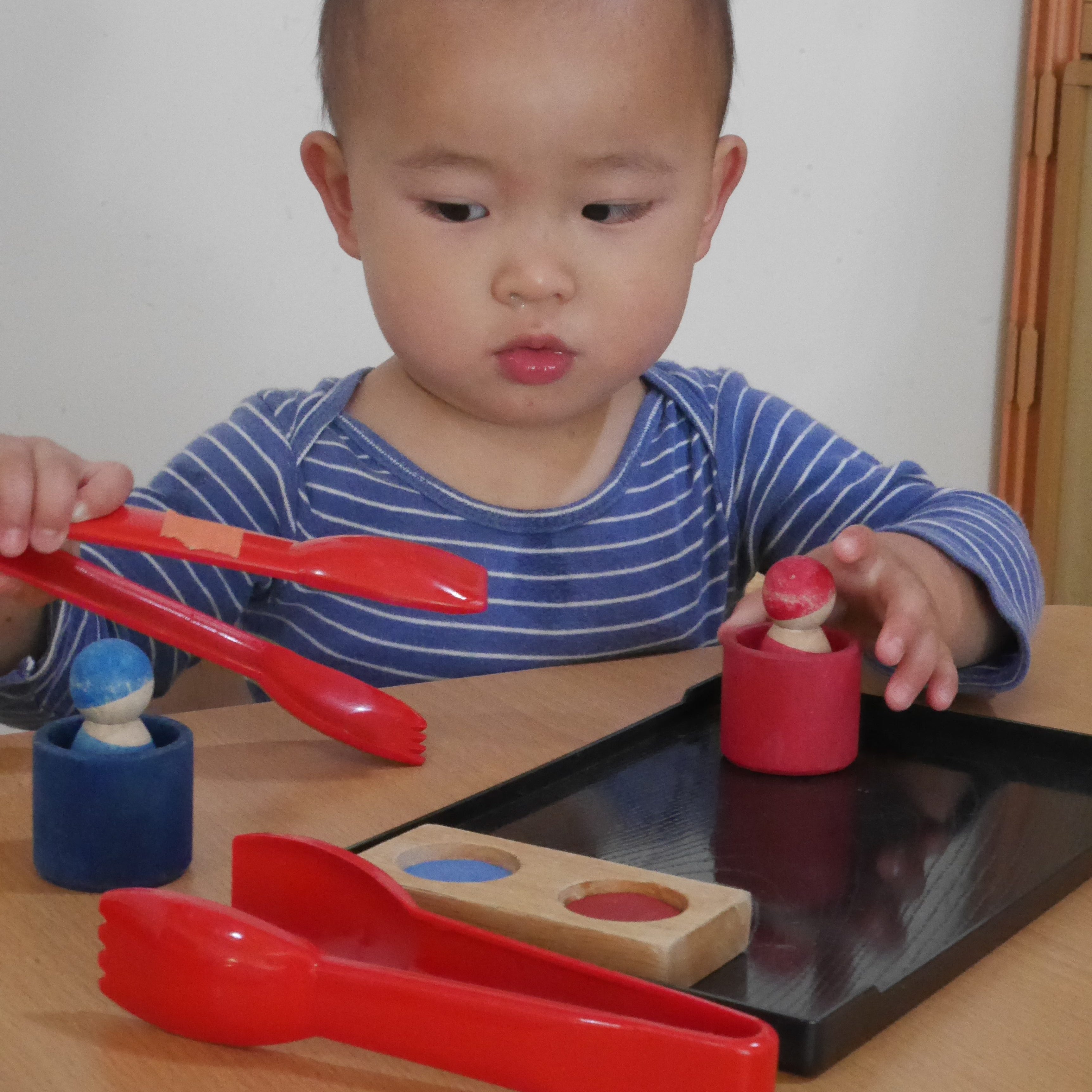 Asian-toddler-with-tongs