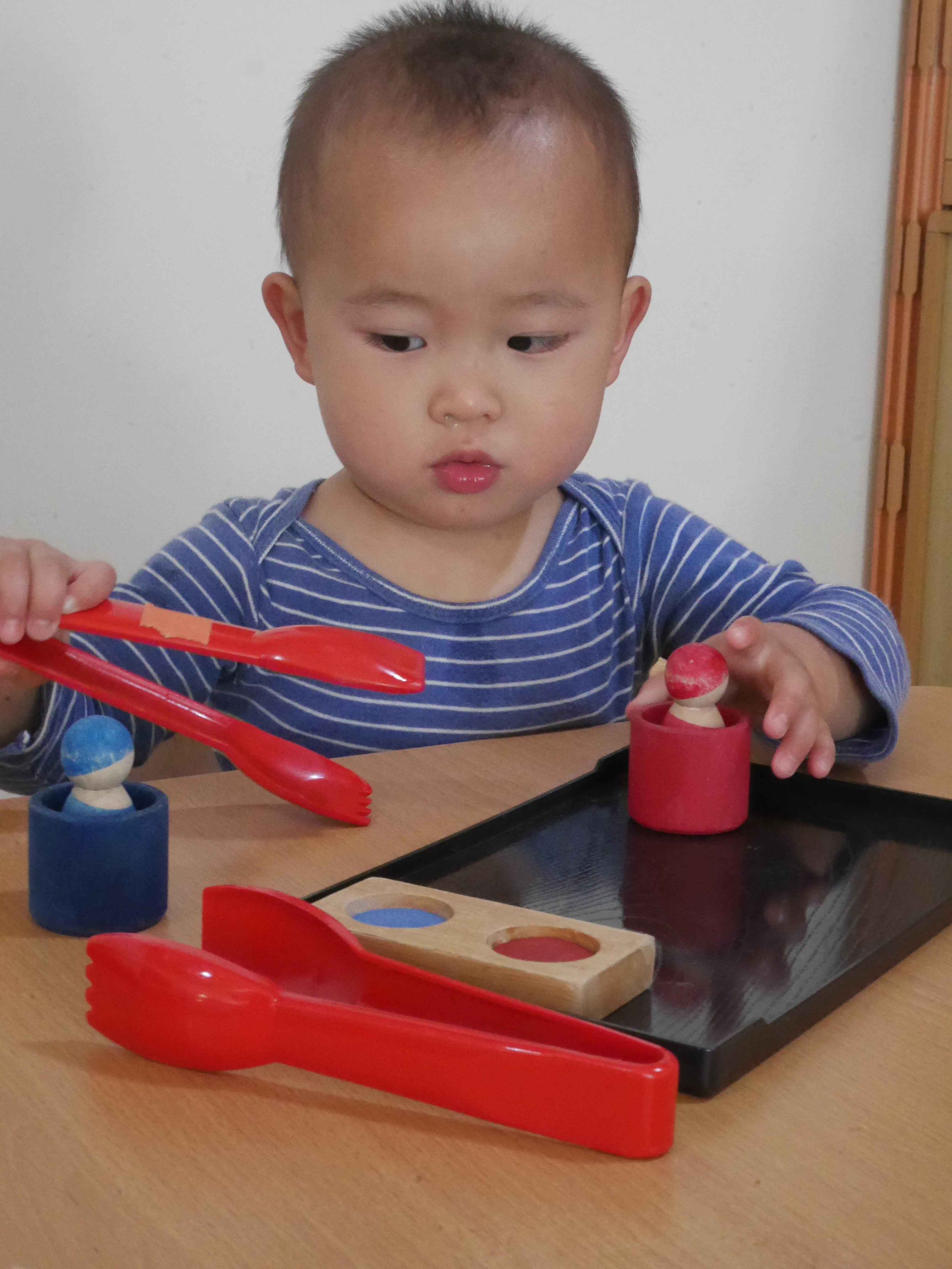 Asian-toddler-with-tongs