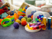 Loose Parts Color Mix set with over 290 colorful textured pieces including pegs, silks, and wool for creative play