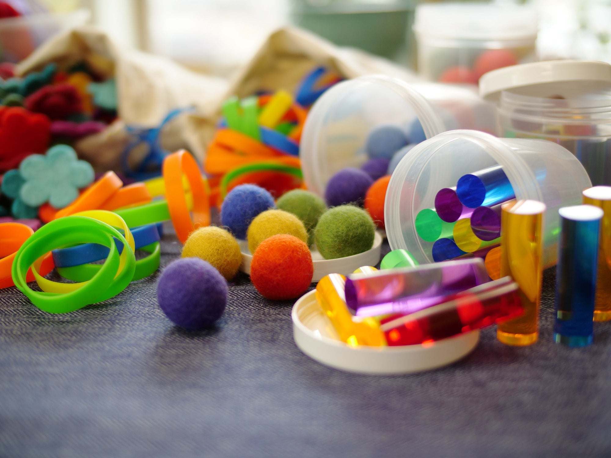 Loose Parts Color Mix set with over 290 colorful textured pieces including pegs, silks, and wool for creative play