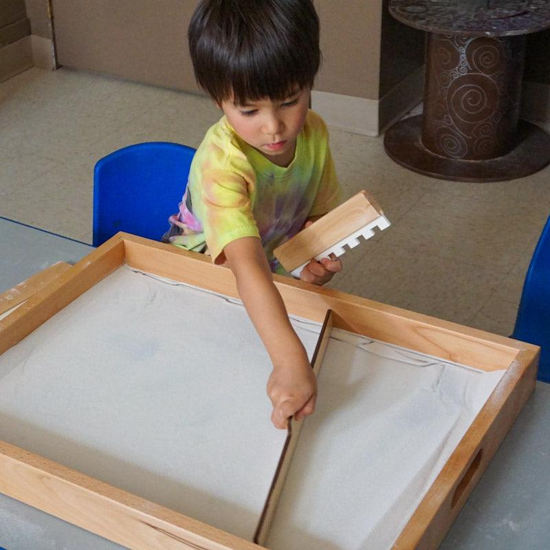 Transparent sand tray with light beneath for sensory play and STEM exploration in classroom