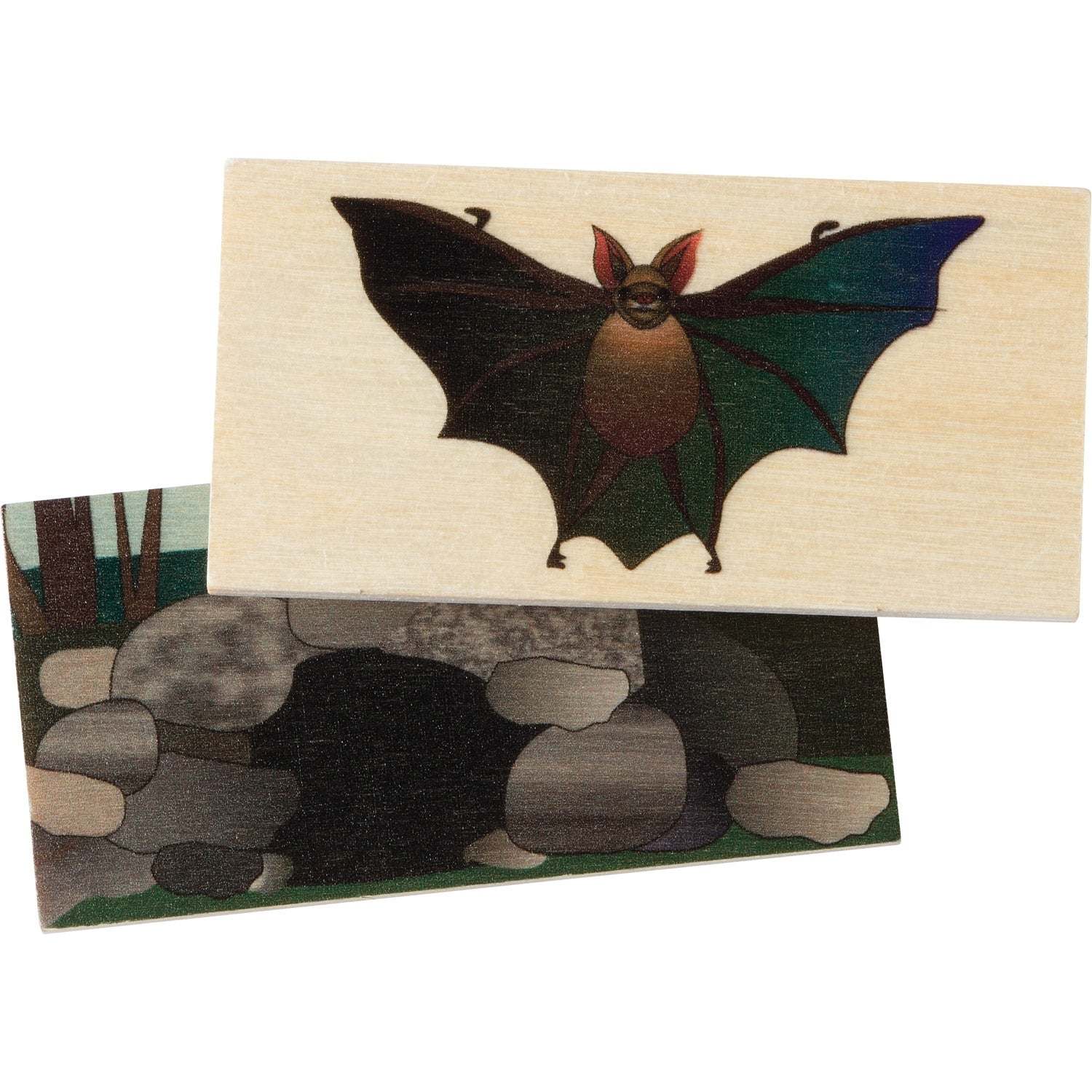 Two wooden matching tiles featuring a detailed bat illustration and its rocky cave habitat for an educational game.