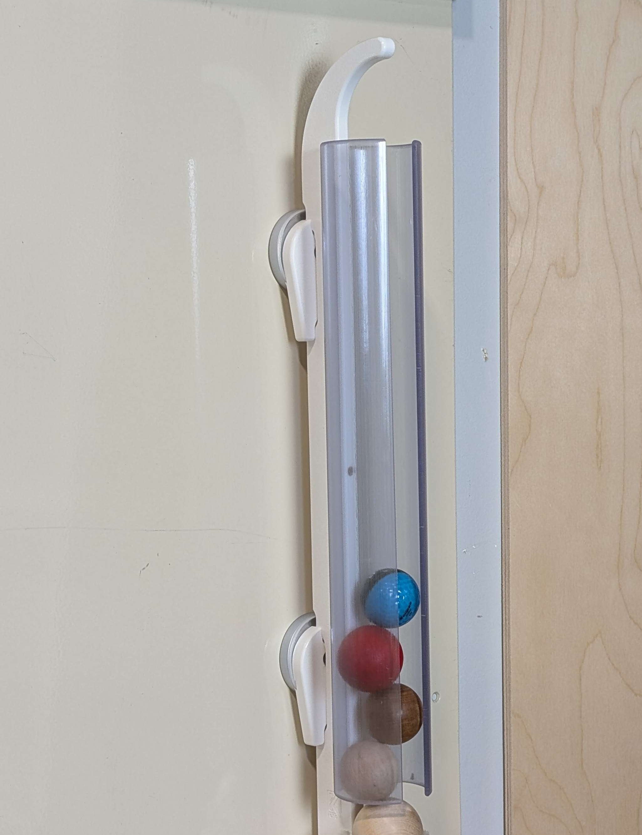 Ball Holder mounted on wall with colorful balls for interactive play and learning