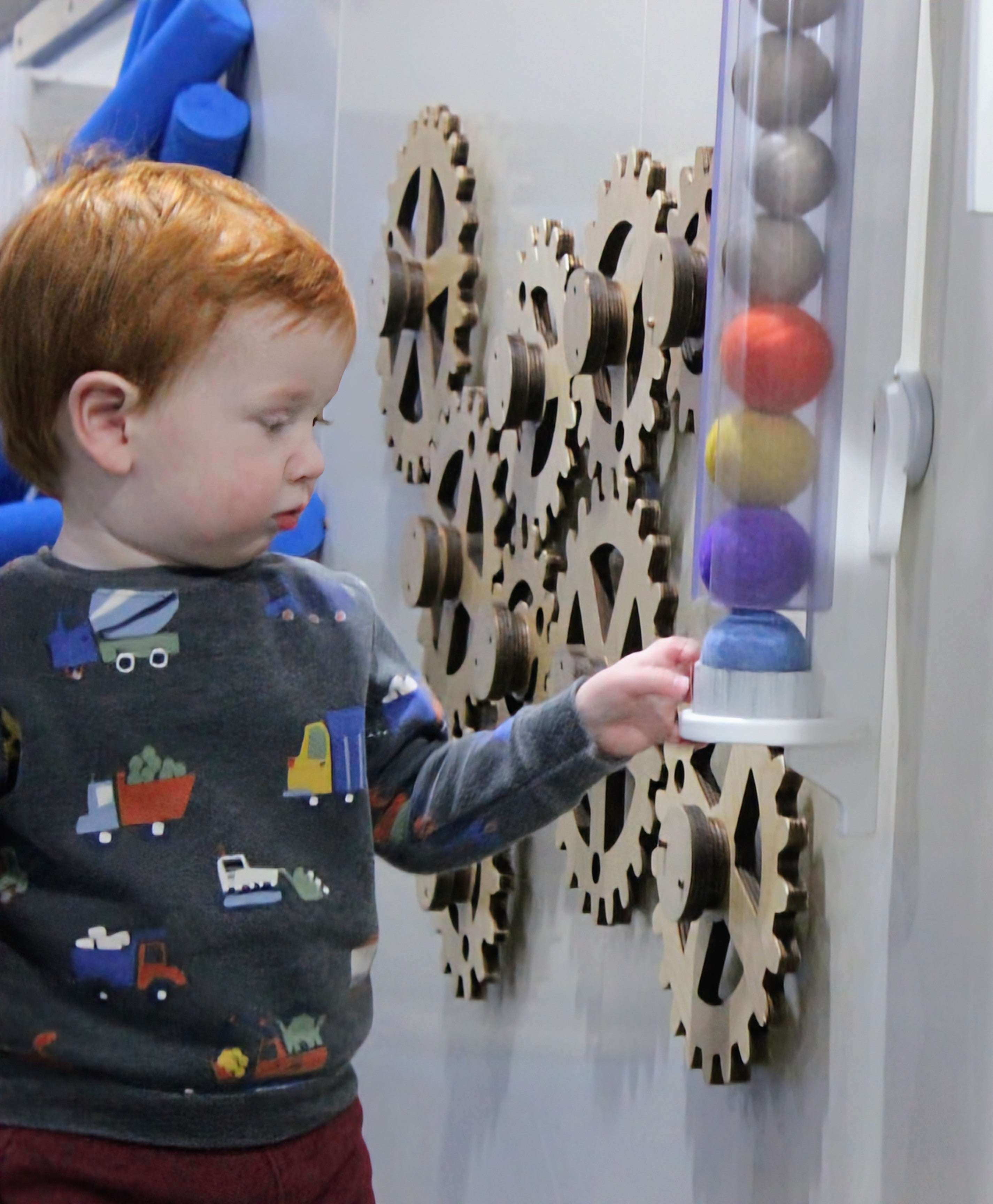 Ball Holder mounted on wall with colorful balls for interactive play and learning