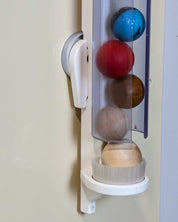 Ball Holder mounted on wall holding colorful balls for interactive children's play and learning