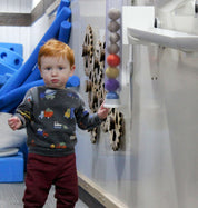 Colorful Ball Holder mounted on wall holding multiple balls for interactive learning and play