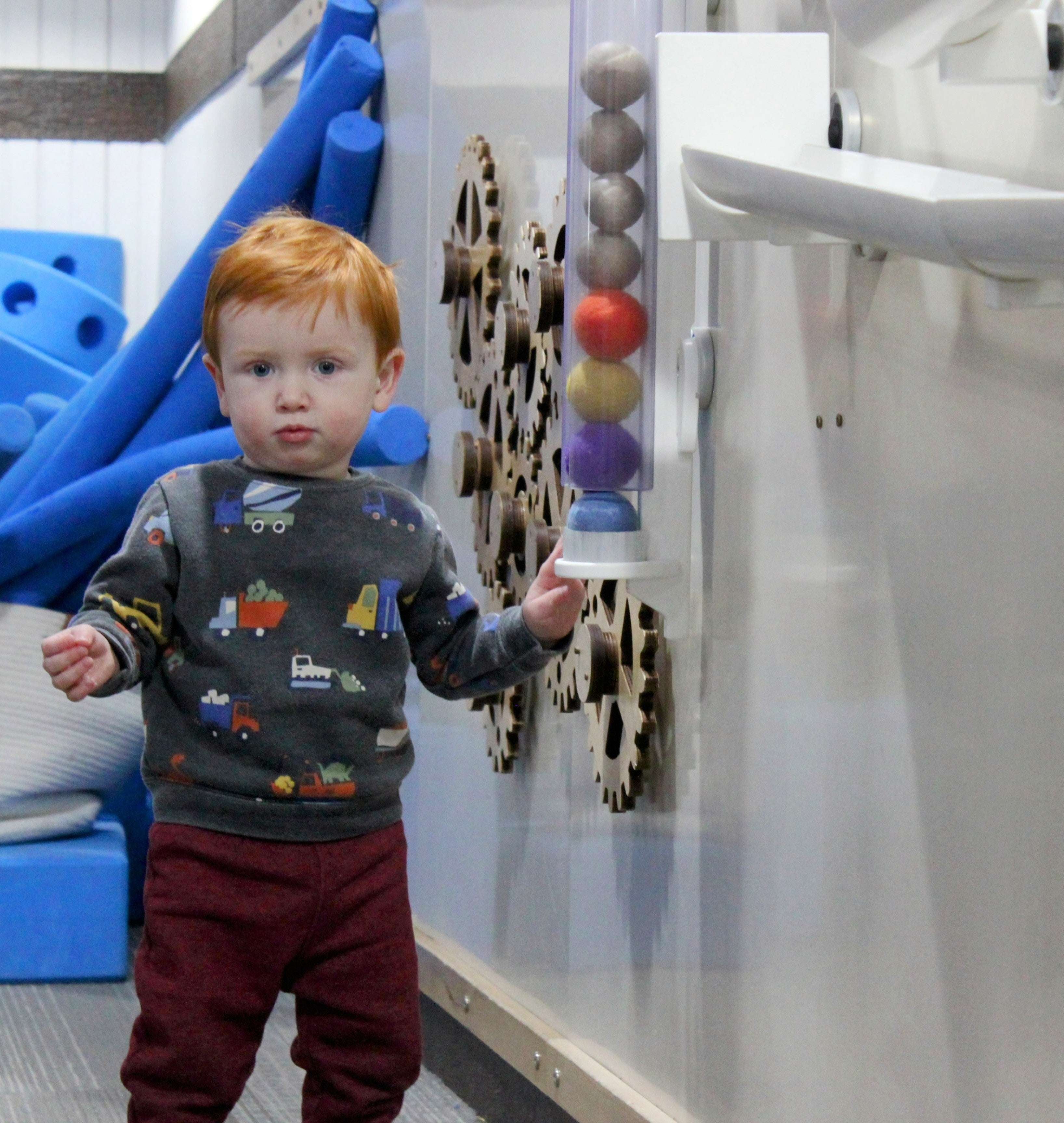 Colorful Ball Holder mounted on wall holding multiple balls for interactive learning and play