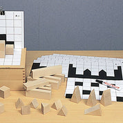 Big Shadows puzzle set with natural wood blocks, geometric shapes, and black-and-white building silhouette pattern cards.
