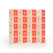Set of 28 wooden blocks featuring embossed Braille, red panels, and clean, modern letters on a white background.