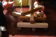 Set of 18 building sticks in cherry, maple, and walnut with rounded edges for stacking and building