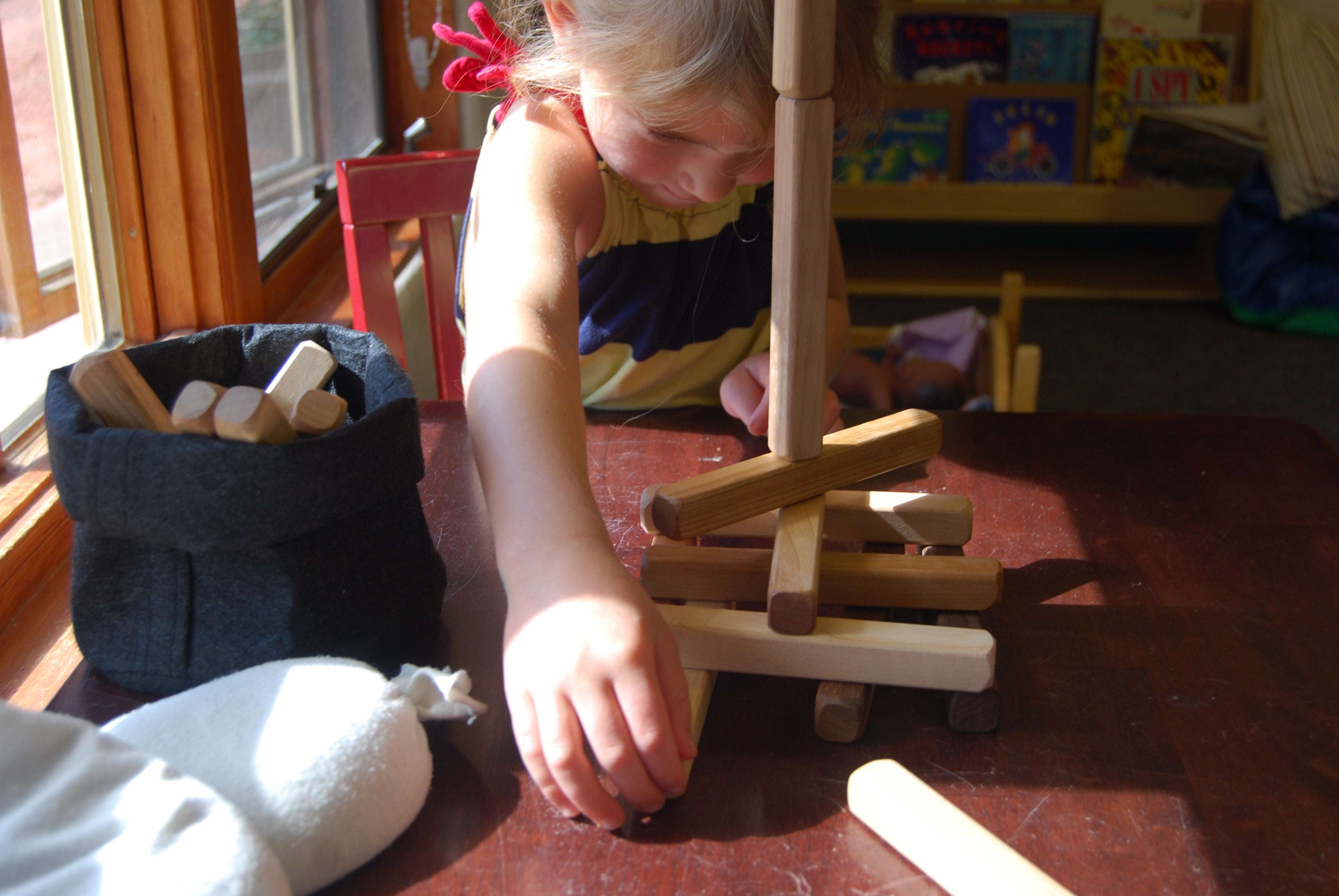 Set of 18 building sticks in cherry, maple, and walnut for stacking and counting