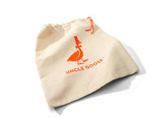 Cream-colored cotton canvas drawstring bag featuring an orange Uncle Goose logo and matching orange drawstring.