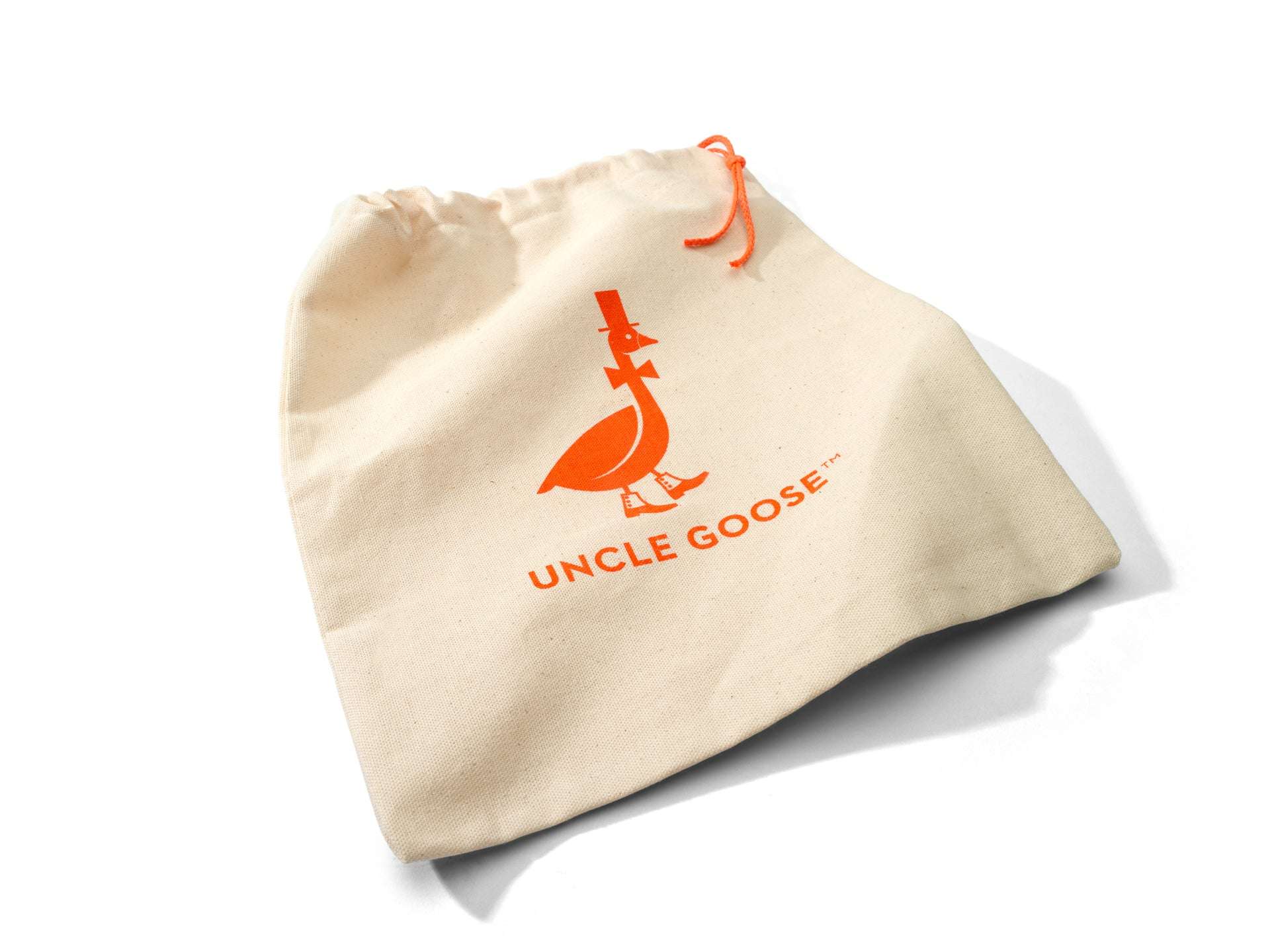 Cream-colored cotton canvas drawstring bag featuring an orange Uncle Goose logo and matching orange drawstring.