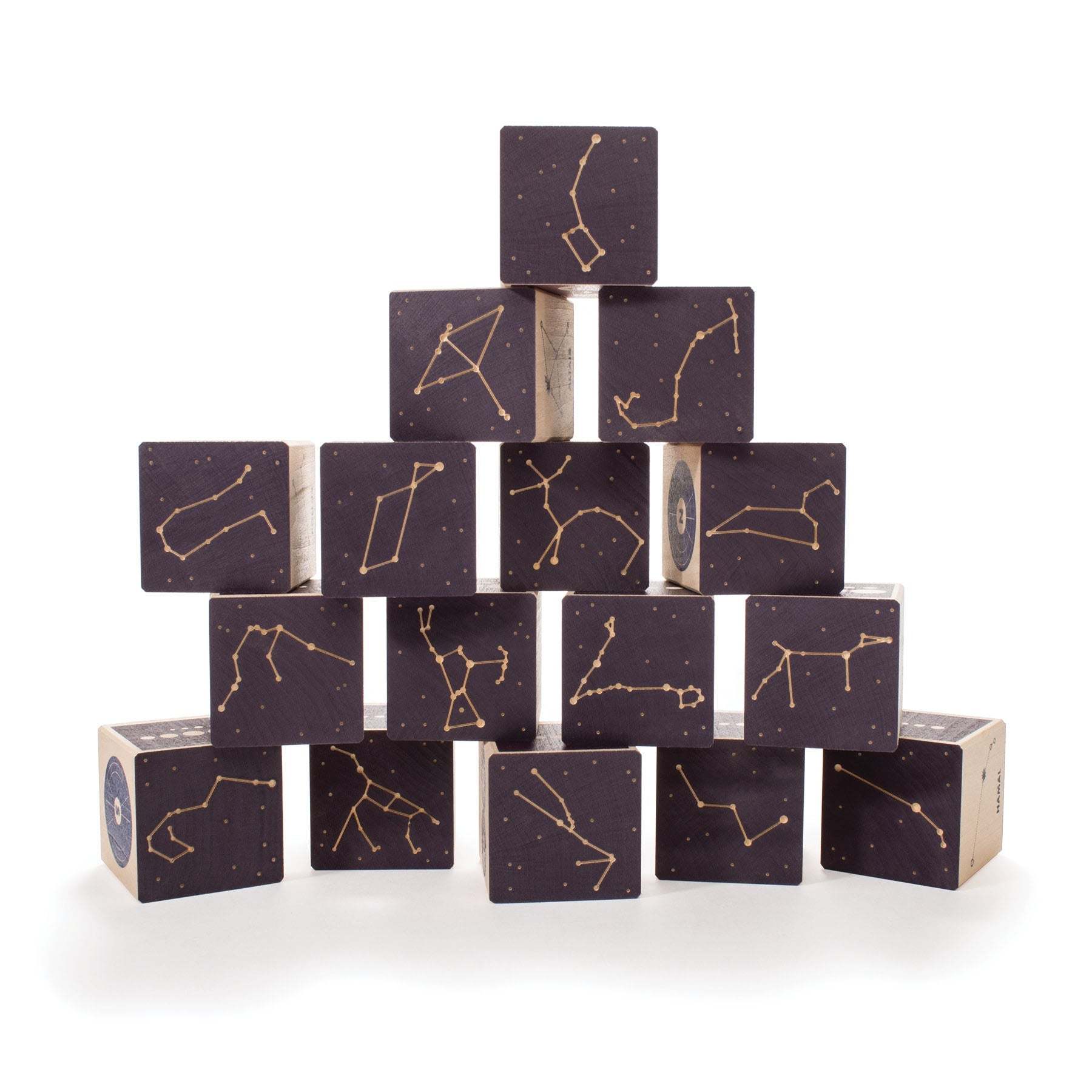 Pyramid of dark wooden blocks featuring debossed gold constellation patterns and star maps on a white background.