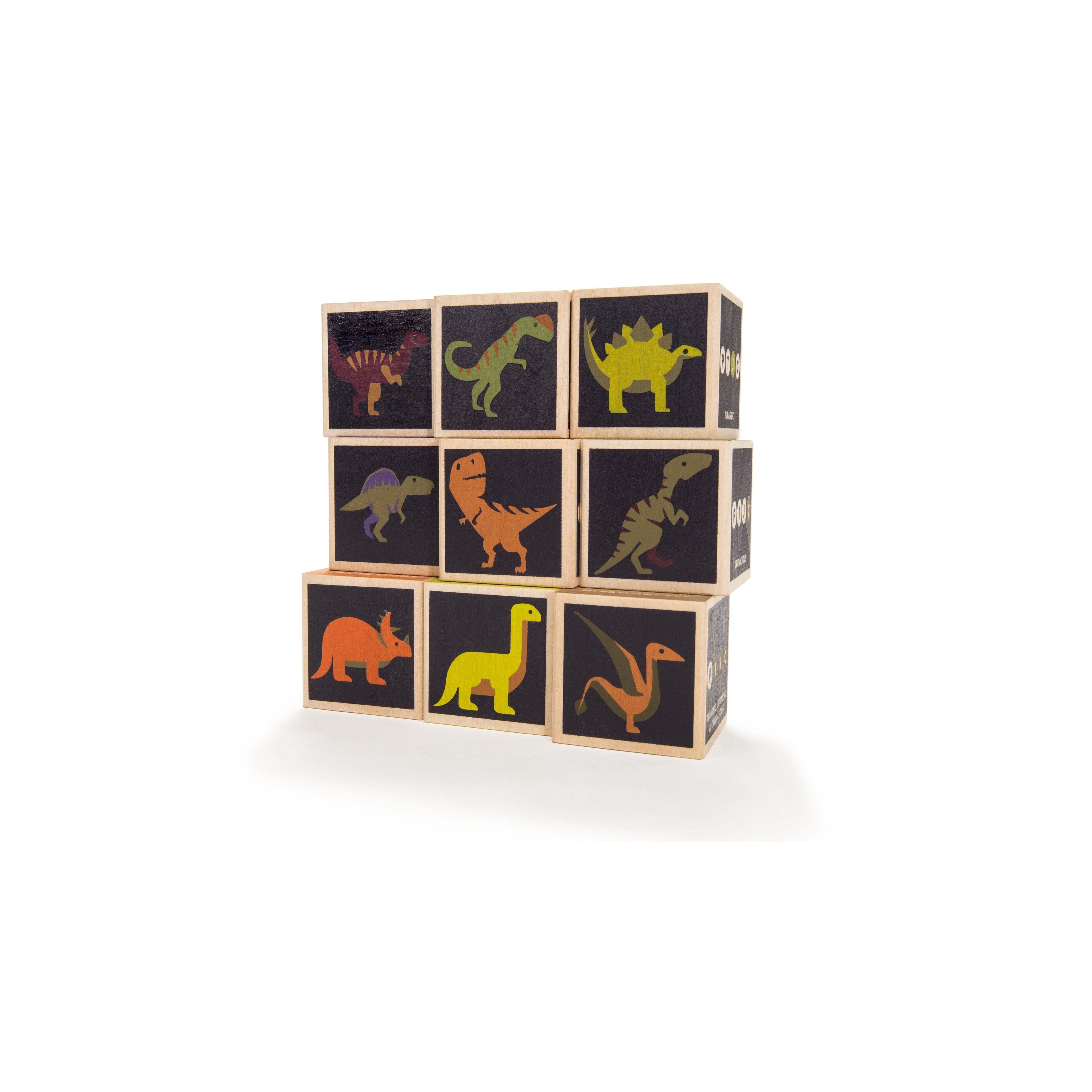 Stack of wooden Uncle Goose dinosaur blocks with colorful illustrations of various prehistoric reptiles on black faces.