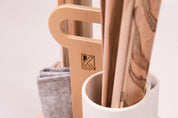 Wooden Kodo ramp caddy with storage tubes, natural wood grain ramps, and a grey canvas pouch on a white background.