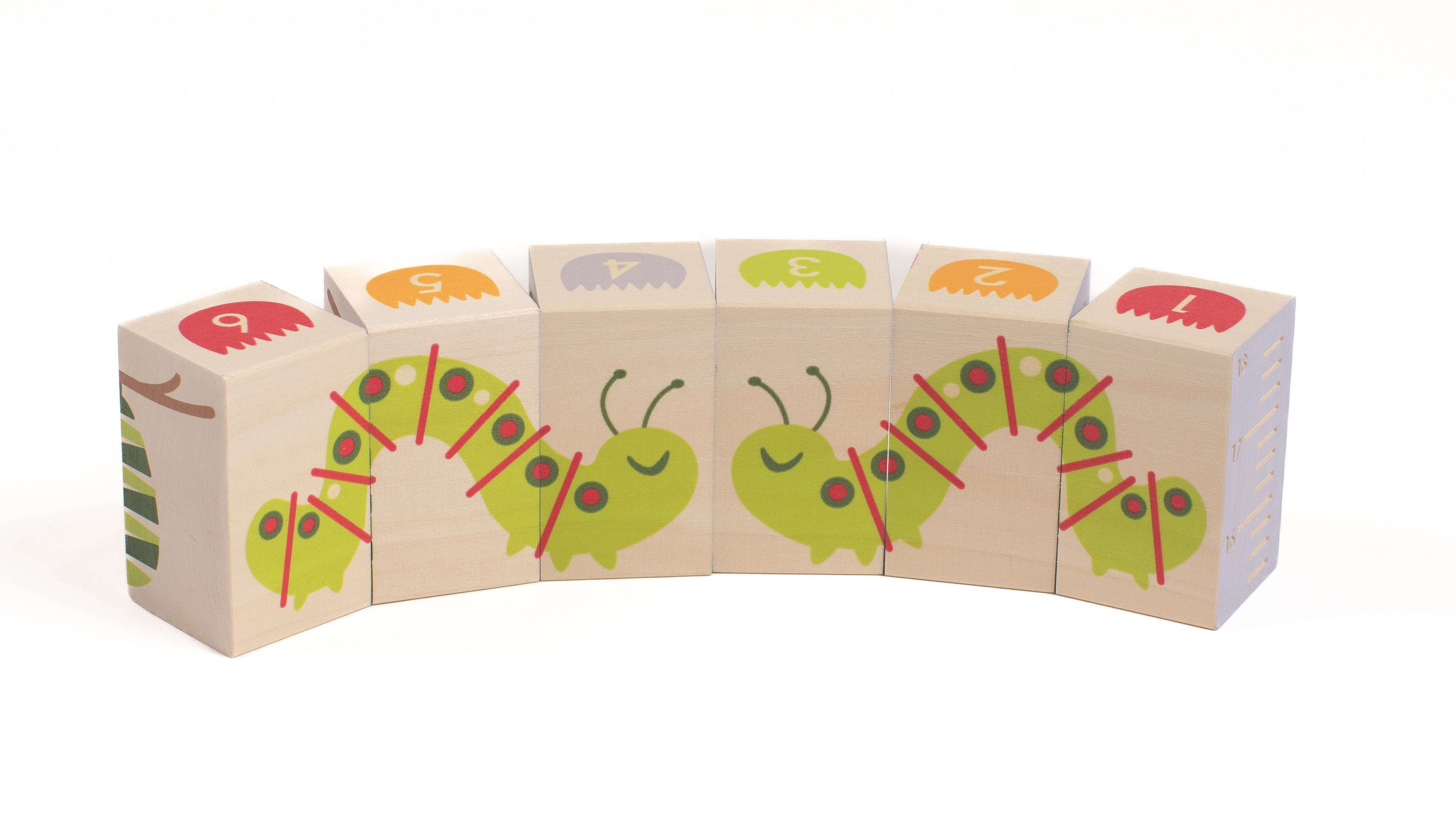 Six wooden blocks featuring a green caterpillar, colorful numbered flowers, and a side ruler for garden learning activities.
