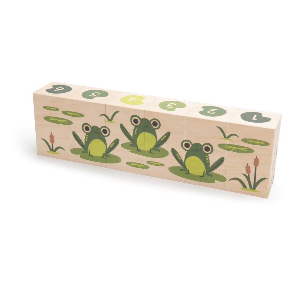 Six wooden basswood blocks featuring swamp illustrations of frogs, lily pads, and numbered tops for educational play.