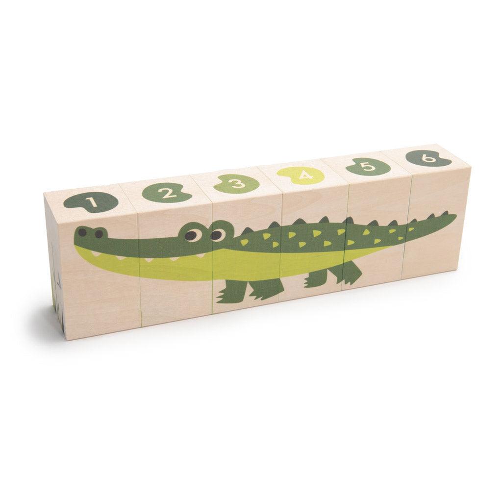 Six wooden basswood blocks featuring a green alligator illustration and numbered lily pads on a white background.