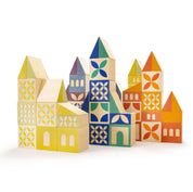 Handmade wooden building blocks with colorful geometric patterns, debossed doors, windows, and triangular roof shapes.