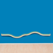 Wooden Hill and Valley wall track with a green base mounted on a blue wall for toddler vehicle play.