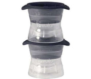 Two stackable Tovolo ice molds made of clear plastic with dark grey silicone lids and rims.