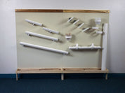 Two beige magnetic wall panels with Wormy Maple trim, featuring white magnetic ramps, cups, and balls for STEM play.