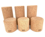 Set of six cylindrical Korxx cork building blocks in varying heights with a natural tan textured finish.