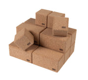 Set of large, natural brown cork building blocks in cube and rectangular shapes with the Korxx logo printed on each.