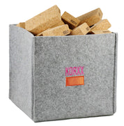 Lightweight cork building blocks stored in a grey felt storage bin with the Korxx logo.