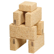 Stack of natural, lightweight cork building blocks with smooth, beveled edges and the Korxx logo branded on the sides.