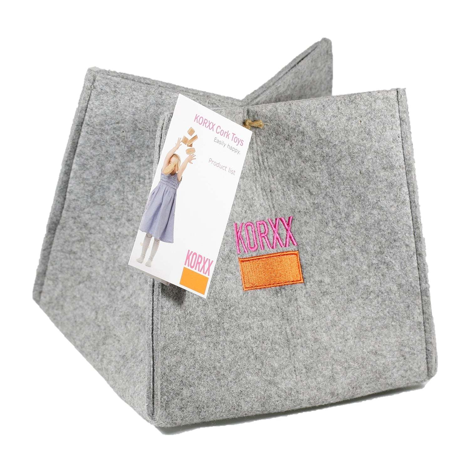 Grey felt storage basket for Korxx cork building blocks with a branded orange patch and product tag.