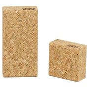 Two natural cork Korxx building blocks with beveled edges and branded tops on a white background.