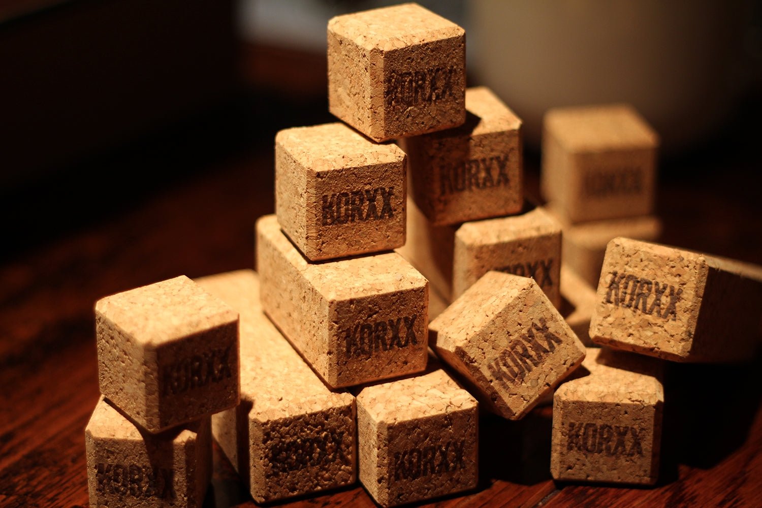 Stack of natural, sustainable cork building blocks branded with the Korxx logo in a cube and rectangular design.