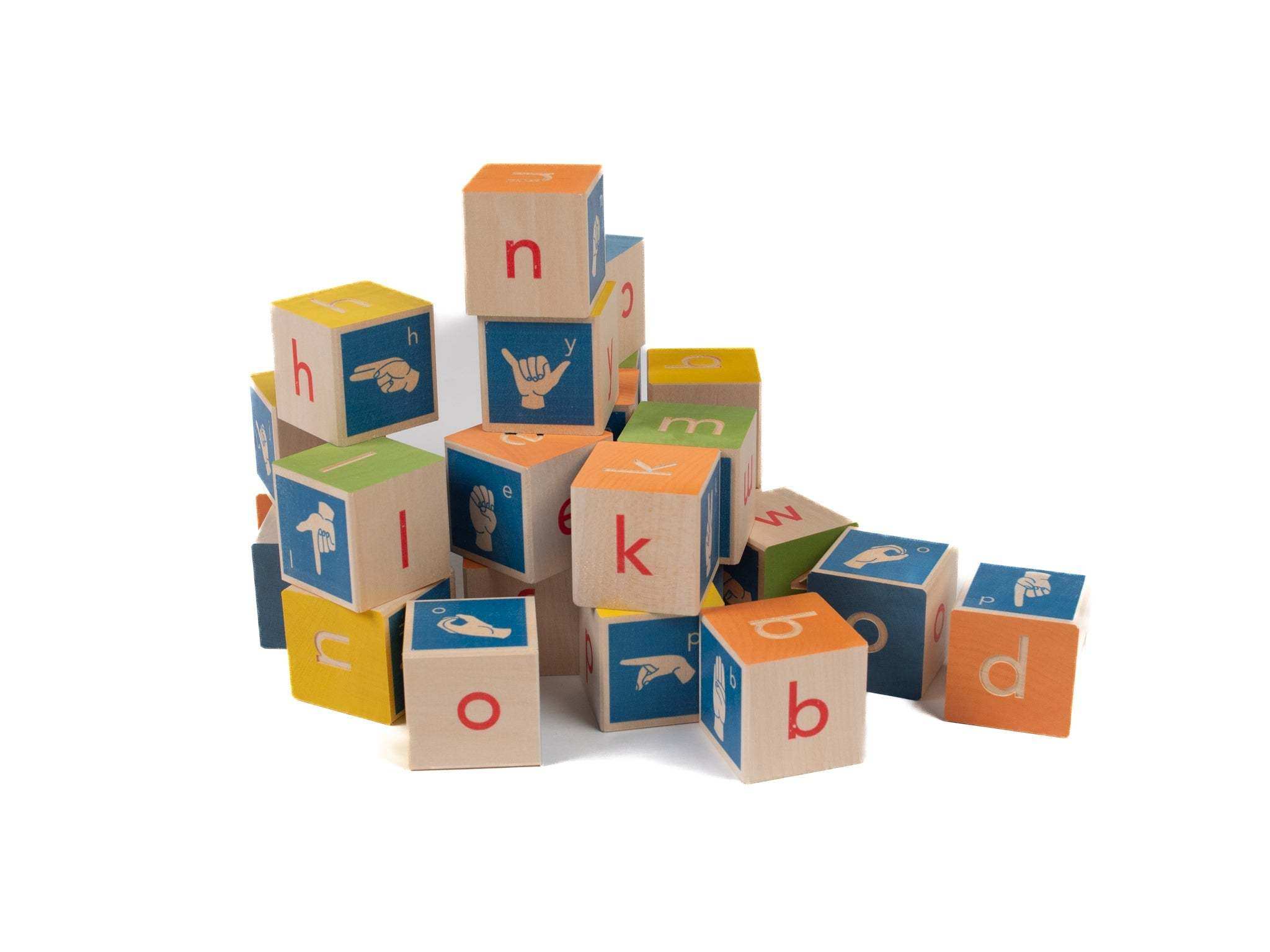 Stack of colorful wooden alphabet blocks featuring letters and American Sign Language hand signs on white.