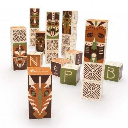 Wooden stacking blocks featuring colorful tribal mask designs, animal patterns, and letters on a white background.
