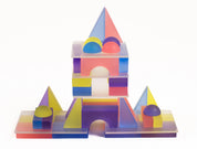 Frosted, colorful translucent building blocks arranged into a castle shape with geometric shapes and arches.