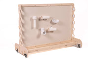 Light wood mobile magnet wall featuring various white PVC chutes and tubes attached to the smooth central panel.