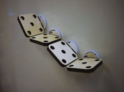 Four square, light-wood mounting platforms with circular holes attached to a magnetic surface with white clips.