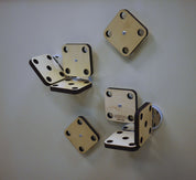 Light wood square magnetic mounting platforms with circular cutouts attached to a wall for engineering projects.