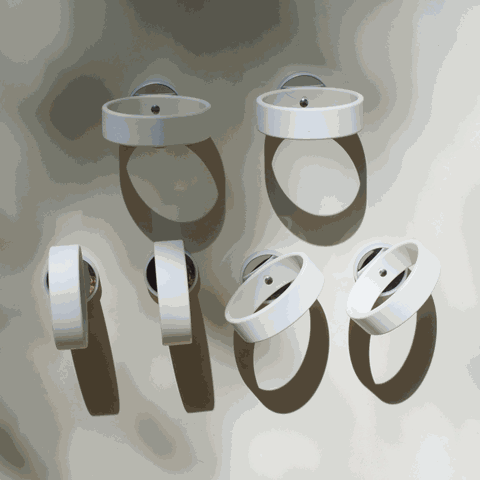 Set of six white circular magnetic rings for wall mounting, featuring a minimalist design for supporting play materials.
