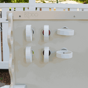 Six white circular magnetic rings attached to a Kodo magnet wall for supporting ramps and materials.