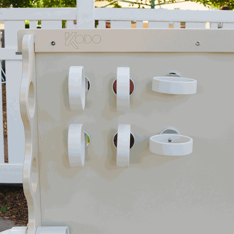 Six white circular magnetic rings attached to a Kodo magnet wall for supporting ramps and materials.