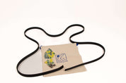 Flexible black rubber track for marble runs with a canvas storage bag, clear yellow marbles, and metal ball bearings.