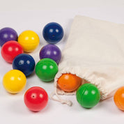 Set of colorful wooden Melody Balls in red, blue, green, yellow, and purple with a drawstring storage bag.