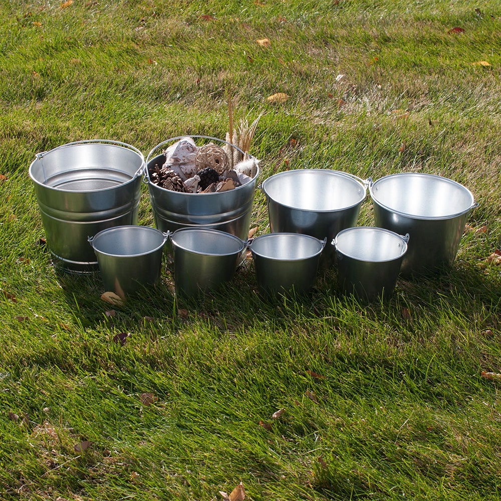 Child using metal pail for outdoor learning activity