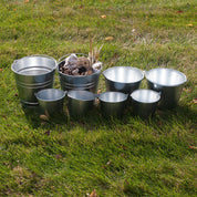 Child using metal pail for outdoor learning activity