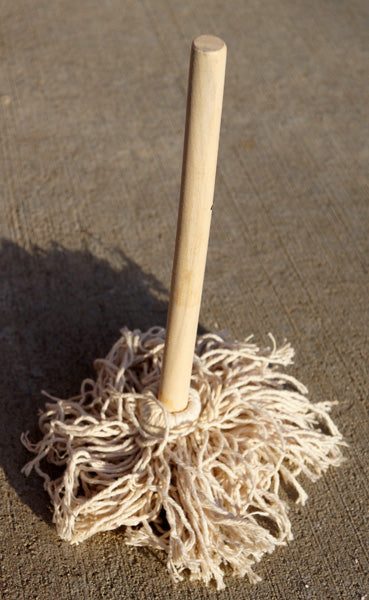 Small mini mop with a smooth wooden handle and thick, off-white cotton string head for painting or cleaning.