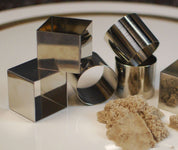 Set of six durable stainless steel square and cylindrical molds for shaping sensory sand or clay.