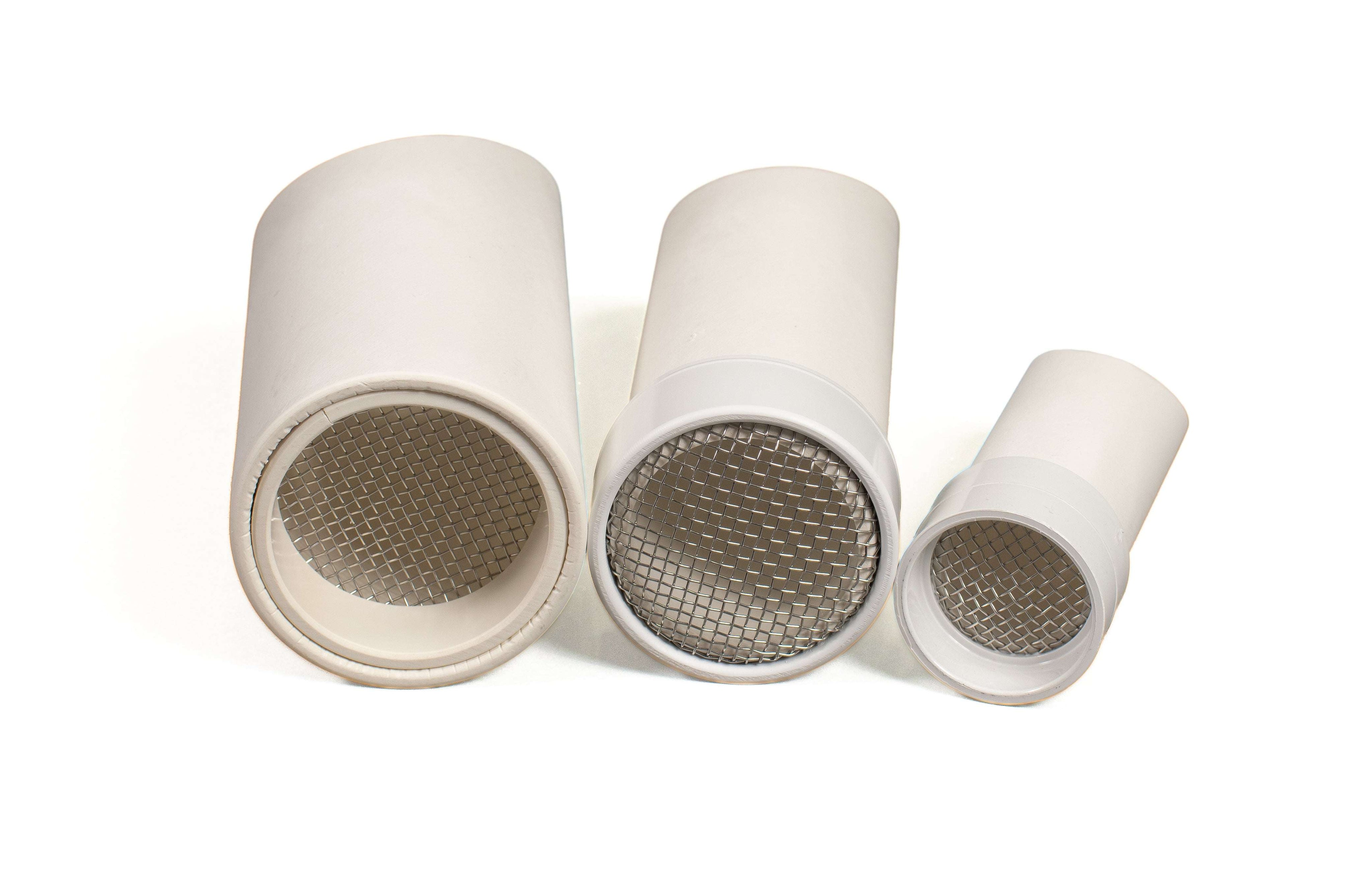 Set of three white cylindrical outdoor sifter scoops with metal mesh screens for sensory play in sand and dirt.